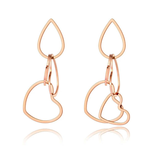 Pendientes asimétricos de acero inoxidable y titanio con diseño original: románticos pendientes con dije de corazón de amor.