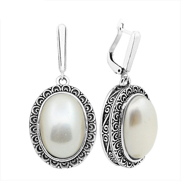 Pendientes grandes de perla ovalada para mujer, estilo vintage, chapados en plata antigua, con colgante de flor.