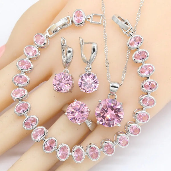 Pulsera, pendientes, collar, colgante y anillos de circonita cúbica rosa en color plata.