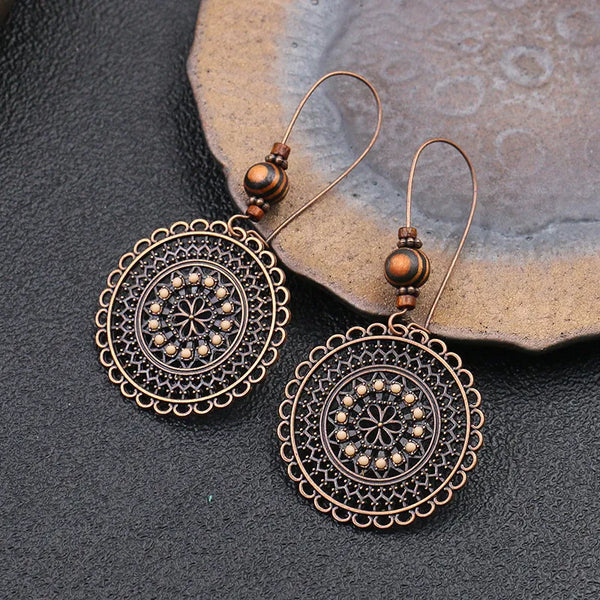 Pendientes colgantes vintage étnicos redondos con diseño de flores huecas para mujer