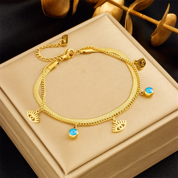 Pulsera con dije de ojos en acero inoxidable 316L color dorado y plateado para mujer