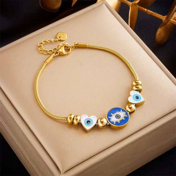 Pulsera de acero inoxidable 316L con dije de corazón redondo y ojos para mujer