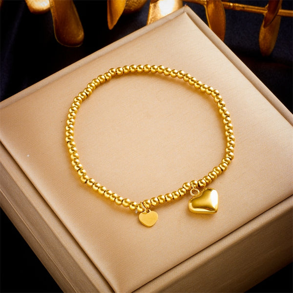 Pulsera de acero inoxidable 316L con cuentas de corazón en color dorado para mujer