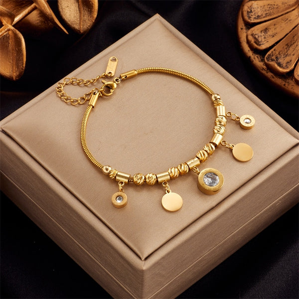 Pulsera de acero inoxidable 316L con circonitas y números romanos en color dorado para mujer