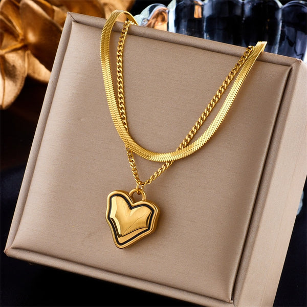 Collar con colgante de corazón de acero inoxidable 316L en color dorado y plateado para mujer