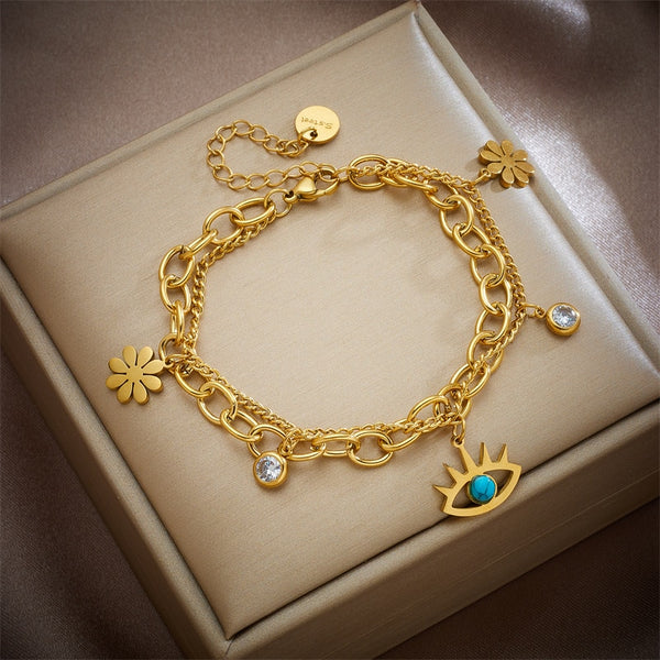 Pulsera multicapa de acero inoxidable 316L con dije de flor y ojo para mujer