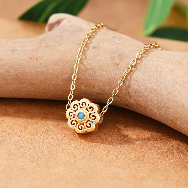 Colgante de flor turquesa con incrustaciones de oro antiguo
