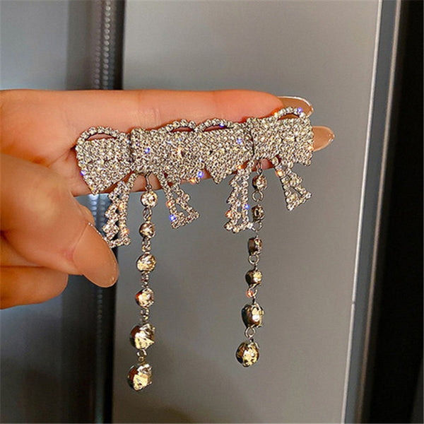 Pendientes colgantes con lazo y diamantes de imitación para mujer, aretes largos con borlas de cristal.