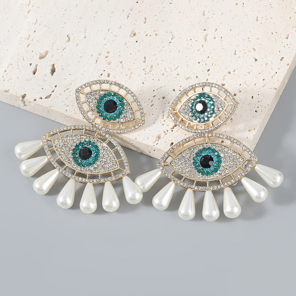 Pendientes de moda con forma de ojo de perla de imitación y diamantes de imitación de metal