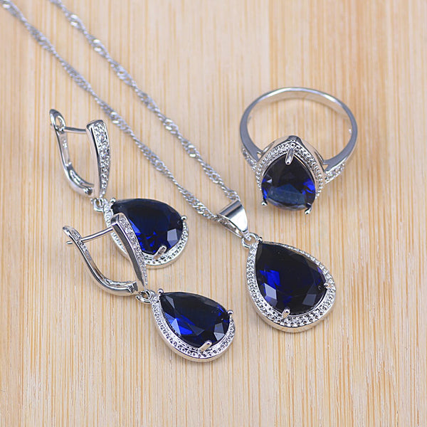 Conjunto de joyas de color plata con piedra azul y gota de agua grande