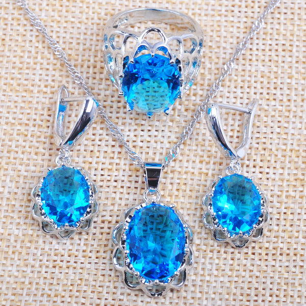 Conjunto de joyería con colgante, pendientes y anillo de circonita ovalada de moda en azul cielo.