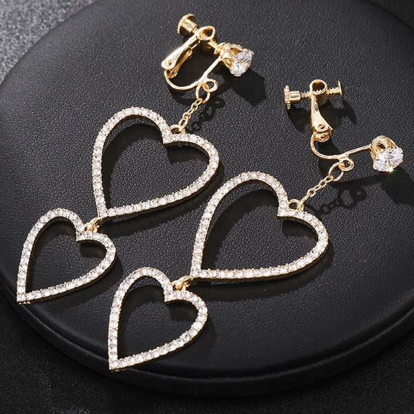 Pendientes de clip con forma de corazón de cristal hueco de moda exagerada