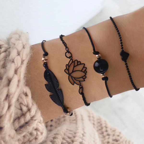 Nuevo conjunto de 4 pulseras góticas de plumas negras con diseño de loto.