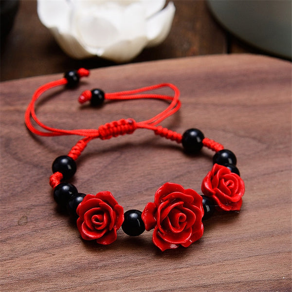 Pulsera étnica artesanal con flor de rosa cinabrio tallada en laca para mujer