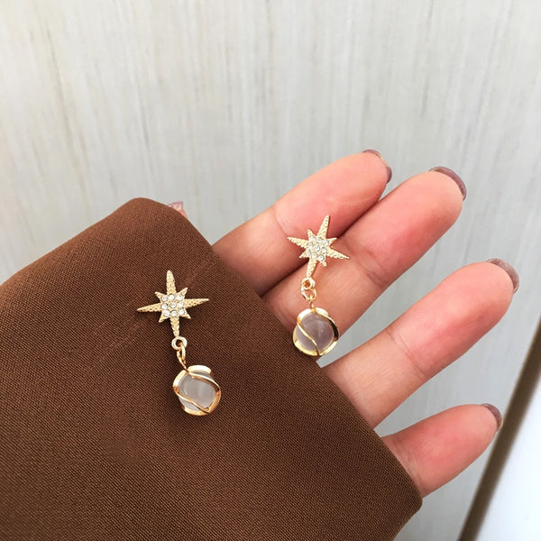 Exquisitos pendientes Rehinstone Cip con estrella de ocho puntas