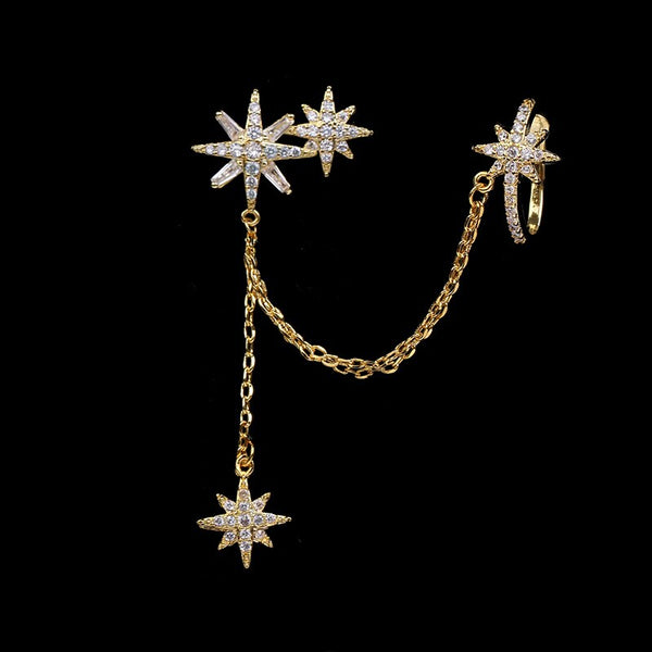 Pendientes de clip con forma de estrella de circonita cúbica y cristales en color oro blanco.