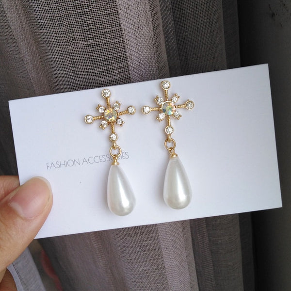 Pendientes de clip de lujo con perlas Rehinstone y estrella de ocho puntas