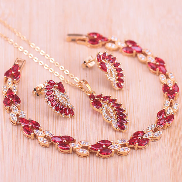 Conjunto de joyas de color dorado con marquesa de piedra roja de muchos colores
